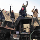 Protesters against the Dakota Access oil pipeline stand on a burned-out truck near Cannon Ball, North Dakota in November 2016.